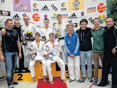 Die fünf Top-Kämpfer in den weißen Anzügen (von links: Paul Pink, Florian Pachel, Tobias Stöckel, Valentin Hethke, Emil Hennebach) mit Betreuern und Teamkollegen. 